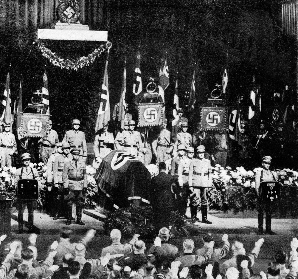 Adolf Hitler salutes at the funeral of Adolf Wagner in the congress hall of Munich's Deutsches Museum
